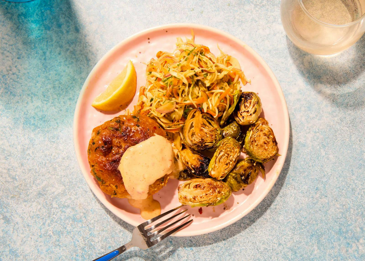 Grilled Bang Bang Shrimp Cake with Brussels Sprouts & Carrot Slaw